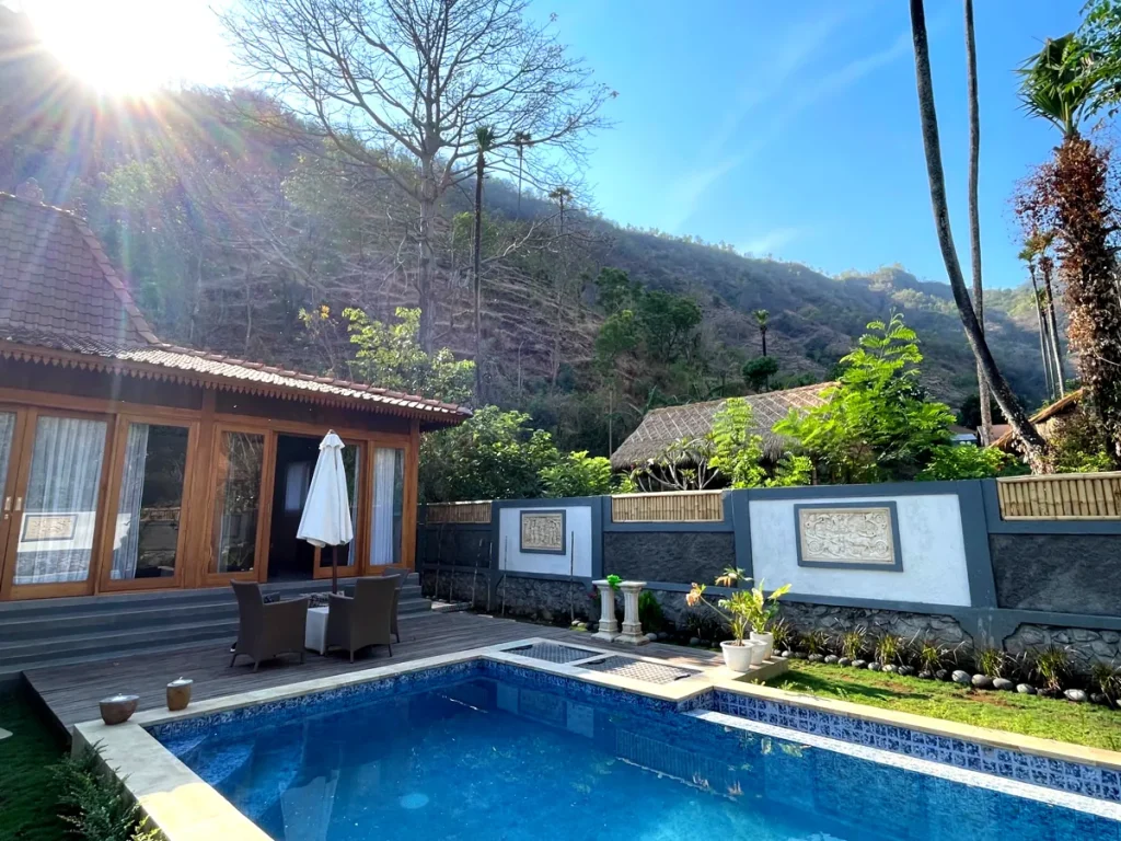 Traditional Joglo-style villa in Amed with a private pool and sun terrace set against the hills.
