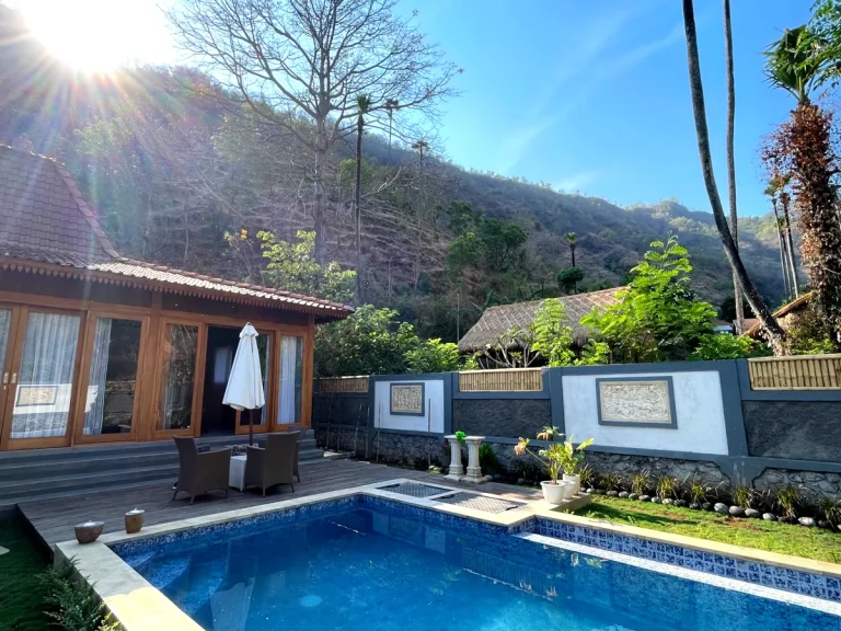 Traditional Joglo-style villa in Amed with a private pool and sun terrace set against the hills.